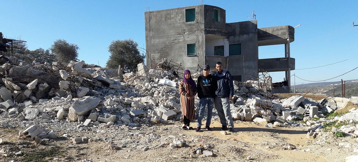 Palestinian refugees stand next to their demolished home in Jenin, West Bank. (file)