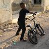 A child plays in front of his destroyed home in the Jenin refugee camp, West Bank. 