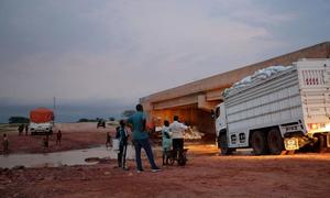 Trucks carrying vital food supplies cross the border from Chad into Sudan via Adre.