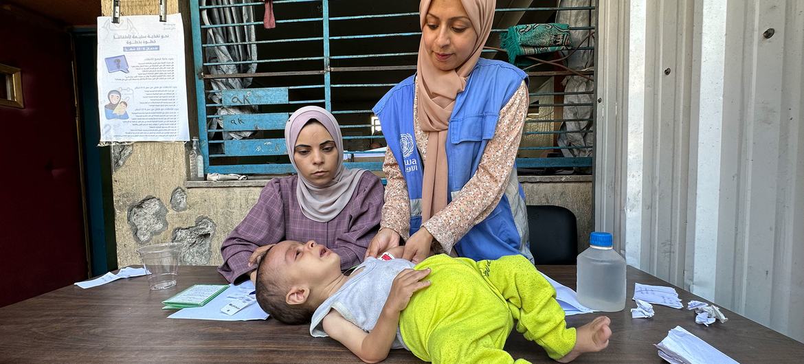 Screening for malnutrition by a worker from the UN agency for Palestinians, UNRWA,in Gaza City.