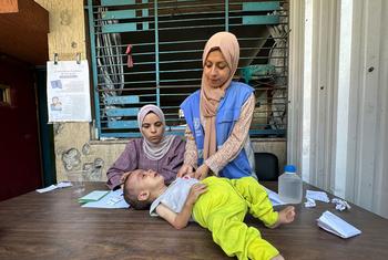Screening for malnutrition by a worker from the UN agency for Palestinians, UNRWA, in Gaza City.