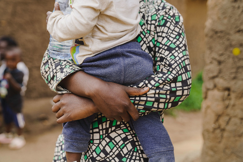 A young mother in the DR Congo, who was raped, holds her 18-month-old baby.