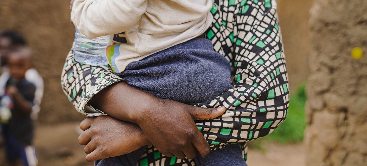 A young mother in the DR Congo, who was raped, holds her 18-month-old baby.