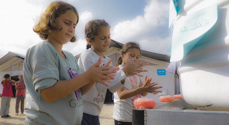 Young girls wash their hands at a UNICEF-supported water point in Gaza.