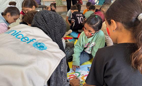 Children in Gaza receive support from a UNICEF worker.