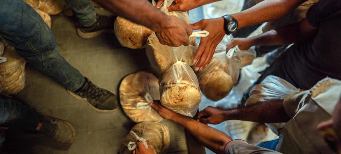 Freshly baked bread is handed out to people in Deir al-Balah, Gaza. Freshly baked bread is handed out to people in Deir al-Balah, Gaza.