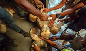 Freshly baked bread is handed out to people in Deir al-Balah, Gaza.