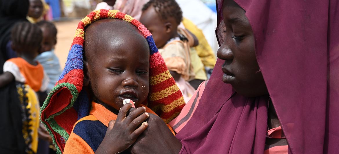 A woman feeds a child at the Adré refugee site in the east of Chad.