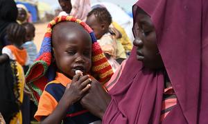 A woman feeds a child at the Adré refugee site in the east of Chad.