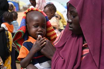 A woman feeds a child at the Adré refugee site in the east of Chad.