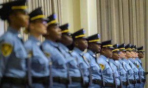 A view of participants during a graduation ceremony for new United Nations security officers. The group consists of thirteen female officers.