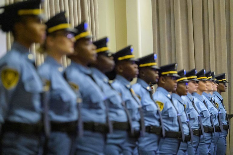 A view of participants during a graduation ceremony for new United Nations security officers. The group consists of thirteen female officers.