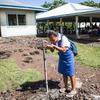 A student drinks clean and safe water from a standpipe at a college on Samoa. i