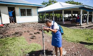 A student drinks clean and safe water from a standpipe at a college on Samoa. i