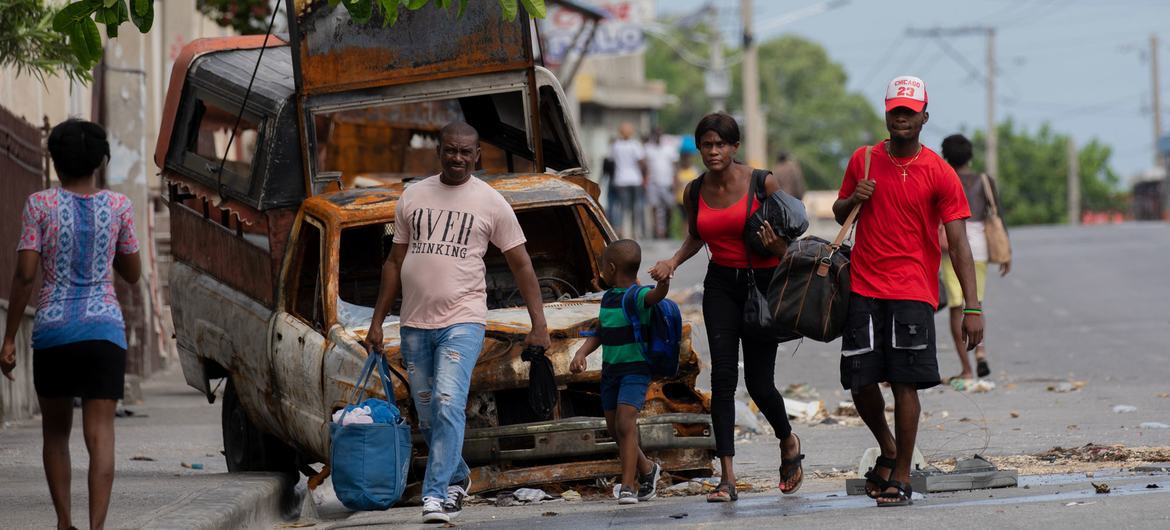 People flee the neighbourhood of Solino in Port-au-Prince following gang attacks there in May 2024.