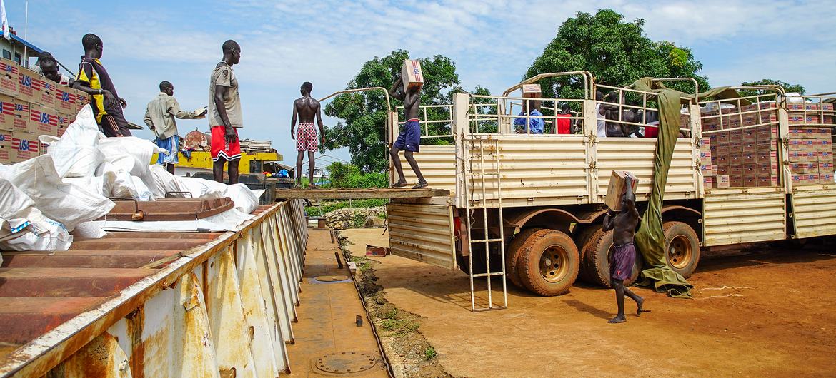 Food aid is loaded onto a Nile River barge for delivery to remote communities. Food aid is loaded onto a Nile River barge for delivery to remote communities.