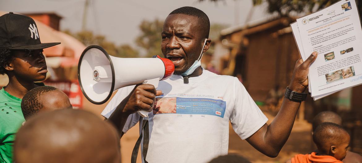 A community outreach worker raises awareness about mpox in Kamanyola, South Kivu province, DR Congo. 