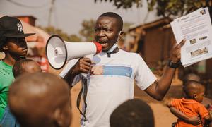 A community outreach worker raises awareness about mpox in Kamanyola, South Kivu province, DR Congo.  