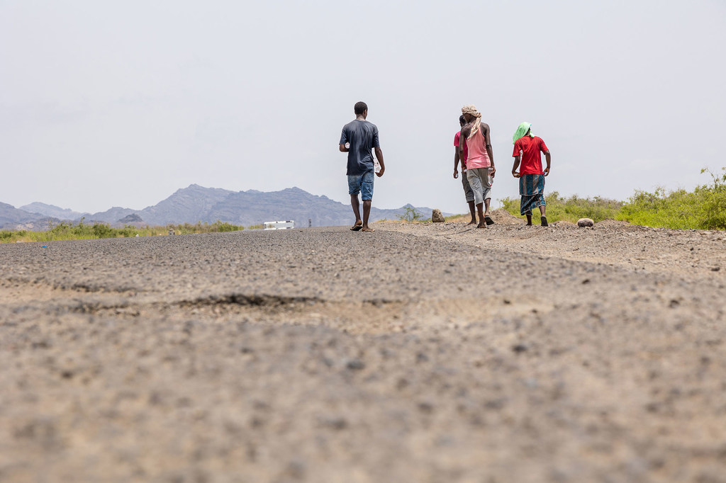 Weary from exhaustion, thirst and hunger, migrants make their way along the road to Lahij in Yemen.