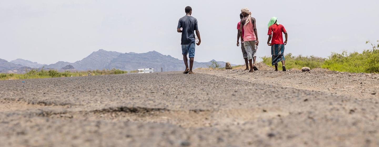 Weary from exhaustion, thirst and hunger, migrants make their way along the road to Lahij in Yemen.