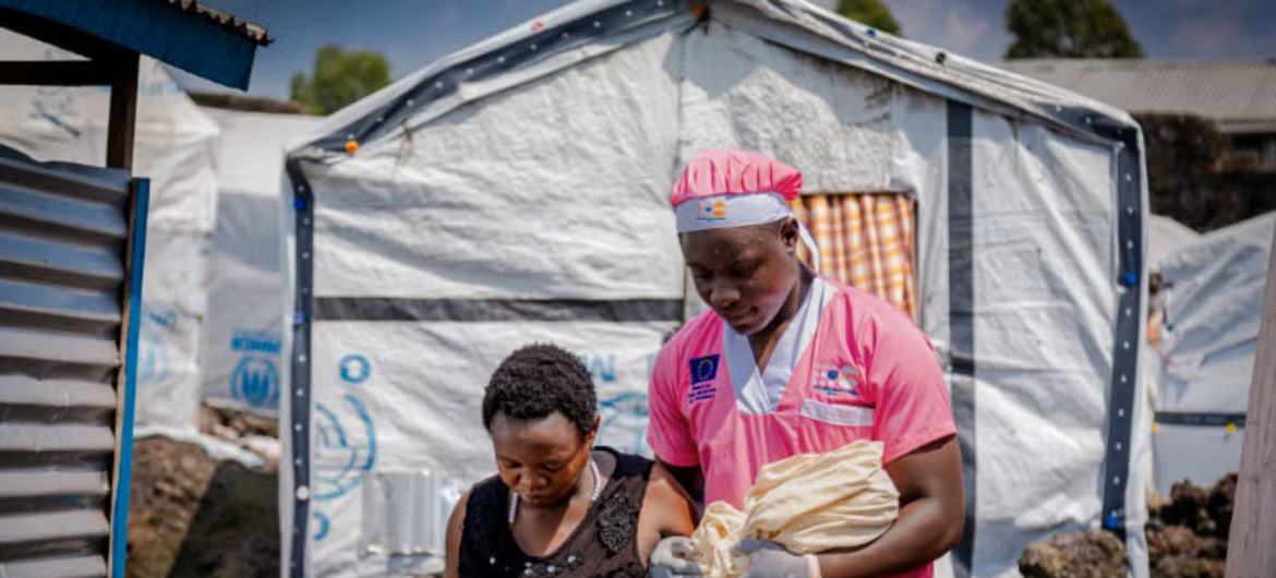 A parteira Loti Kubuya Mielor auxilia uma mulher deslocada recém-chegada que deu à luz em um abrigo em Goma, República Democrática do Congo