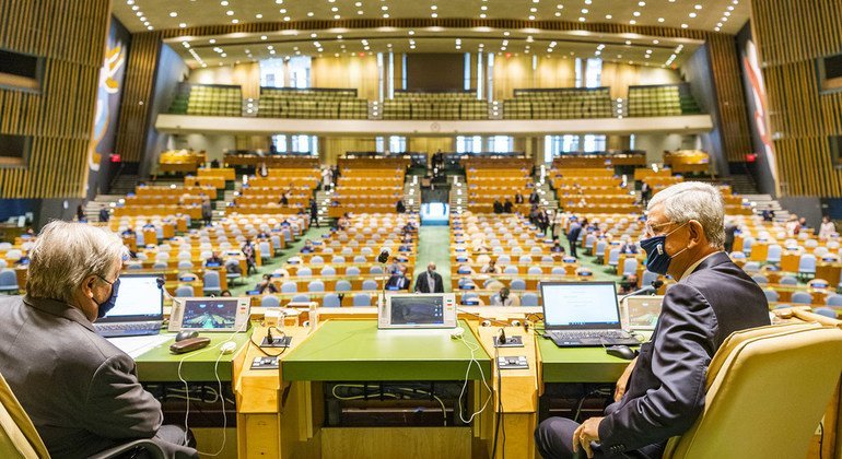 Secretary-General António Guterres (left) speaks with Volkan Bozkir, President of the 75th session of the United Nations General Assembly, ahead of the opening of the General Debate.