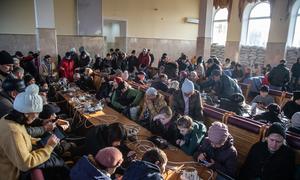 People charge their cell phones and use wifi at the train station in Kherson, Ukraine.