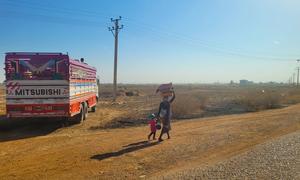 A mother and her child flee for safety amid ongoing clashes in Sudan.