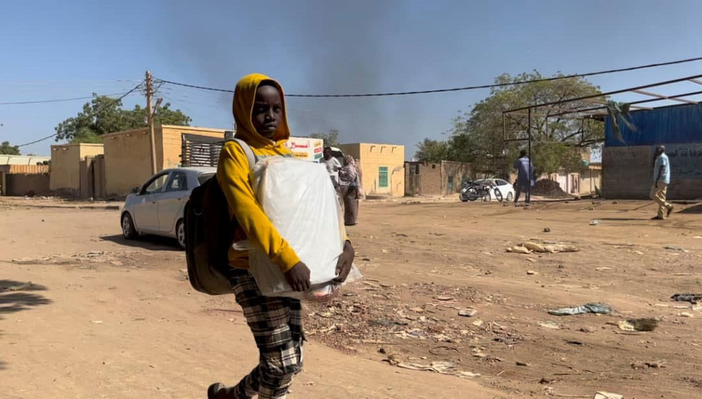A child flees from Wad Madani, Al Jazirah state  east-central Sudan following recent armed clashes there.