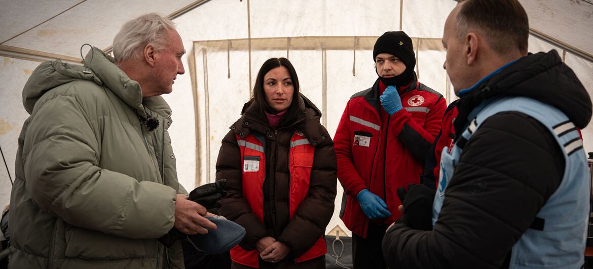 Matthias Schmale, Humanitarian Coordinator in Ukraine, and Andrea De Domenico, Head of UN OCHA in Ukraine, meet with Red Cross staff and volunteers at a heating tent in Boryspil, Ukraine, to discuss support for vulnerable people during extreme winter conditions.