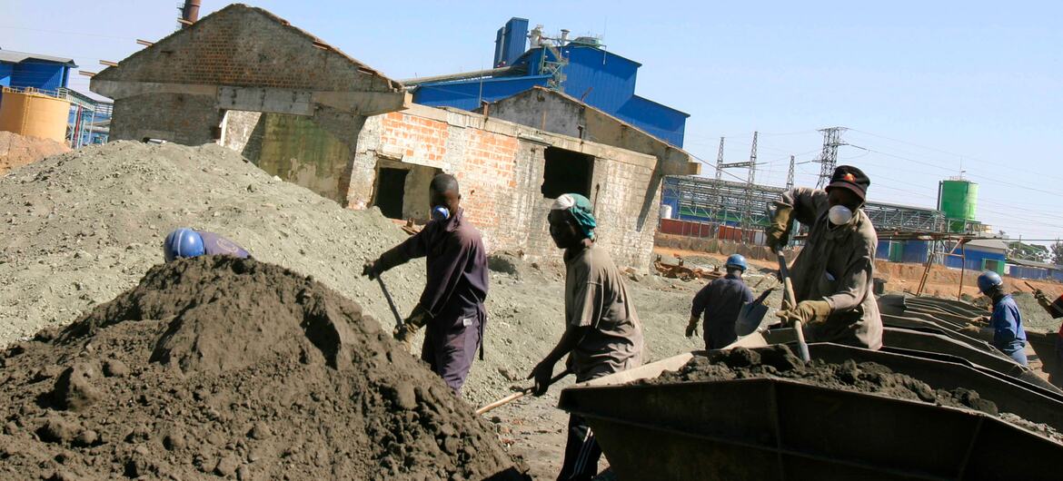 Workers load cobalt and copper ore into railway cars at the Geca Mines processing plant in Lumumbashi, Democratic Republic of Congo.