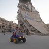 A child rides a toy car as people celebrate Eid al-Fitr, in east Ghouta, Syria.