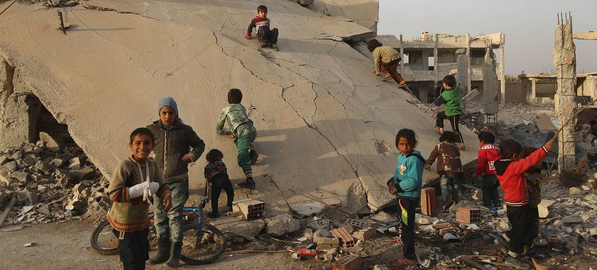 أطفال يلعبون في مبنى مدمر في الغوطة الشرقية في سوريا.