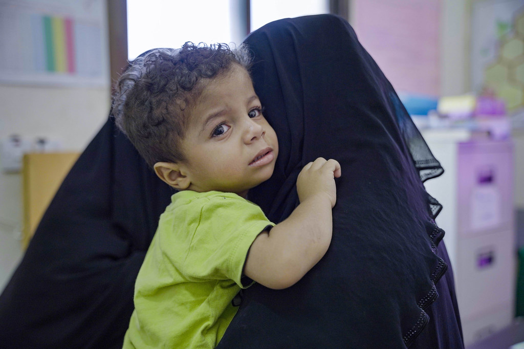A young boy and his mother attend a health centre in Tarim in eastern Yemen.