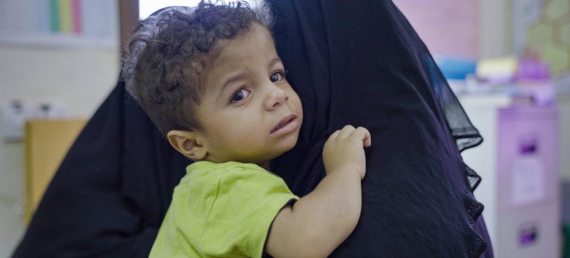A young boy and his mother attend a health centre in Tarim in eastern Yemen.