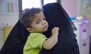 A young boy and his mother attend a health centre in Tarim in eastern Yemen.