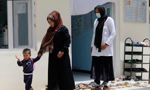 A midwife supports a mother and child at a health centre in the remote Bamyan Province, Afghanistan.