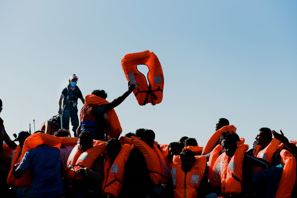 Rescued migrants aboard a boat after being saved from a capsized vessel during a perilous sea crossing.