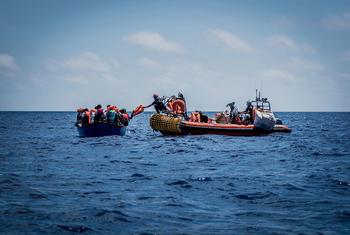 SOS Mediterranee rescue team assists migrants aboard a wooden boat in distress in the Mediterranean Sea, June 25, 2020.