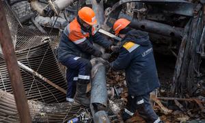 Workers repair damaged power infrastructure in Ukraine. (file)