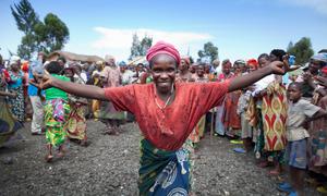 A woman greets members of the Technical Committee of the peace, security and cooperation framework for the Democratic Republic of the Congo and the region during a field visit to the Mugunga camp for internally displacement people near Goma.