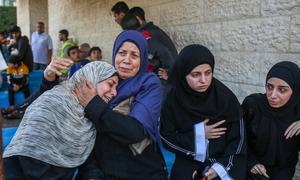 Palestinian women grieve for their relatives who were killed in Israeli bombings in Nuseirat and Deir al-Balah, in the central Gaza Strip.