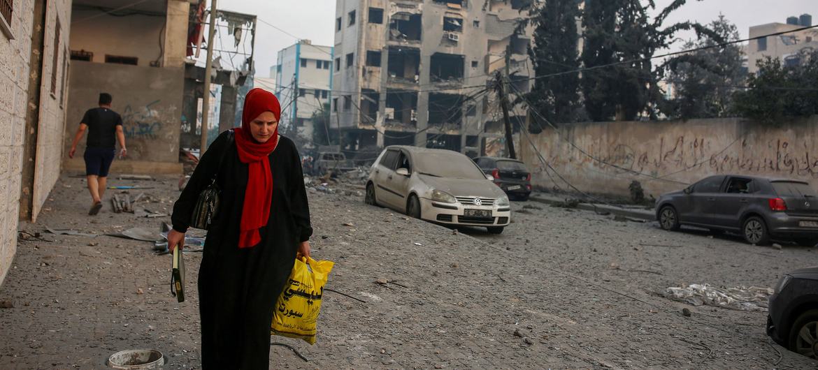 A woman walks next to her destroyed house in the Palestine Stadium area in central Gaza City. (file)