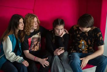 Young adults check social media in North Macedonia.