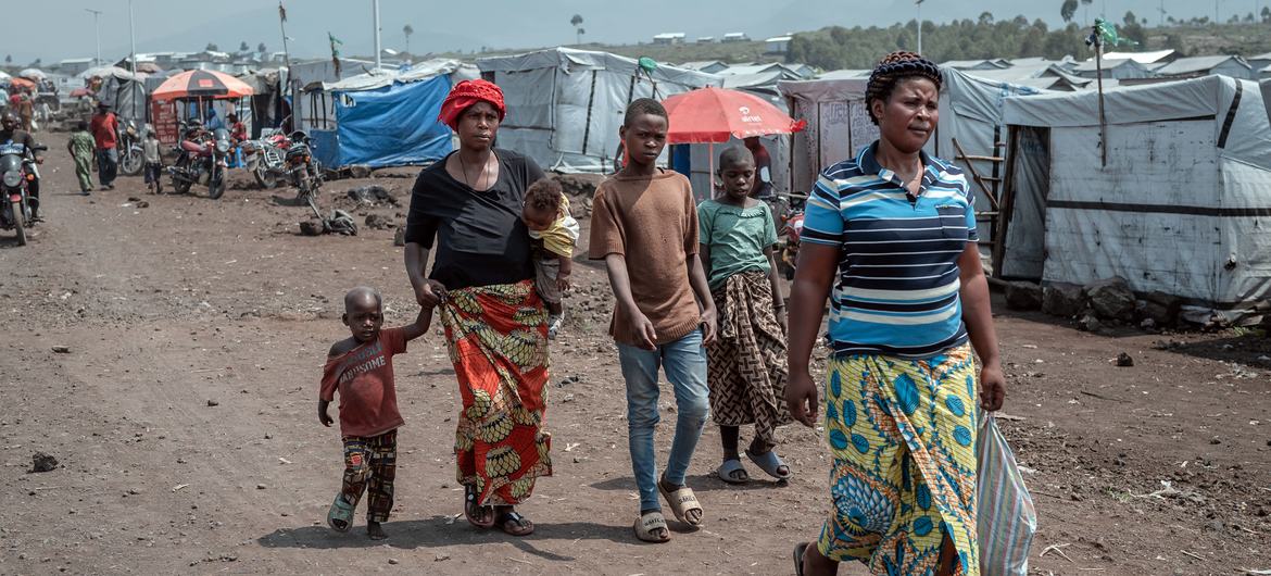 People walk through a camp for displaced people close to Goma in the eastern Democratic Republic of the Congo. 