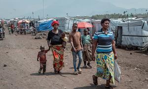 People walk through a camp for displaced people close to Goma in the eastern Democratic Republic of the Congo. 