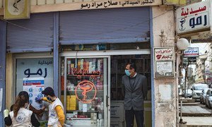 Jirjus works with other volunteers to hang posters providing important instructions on how to protect against the coronavirus, as part of a campaign in the city of Qamishly, northeast Syria.