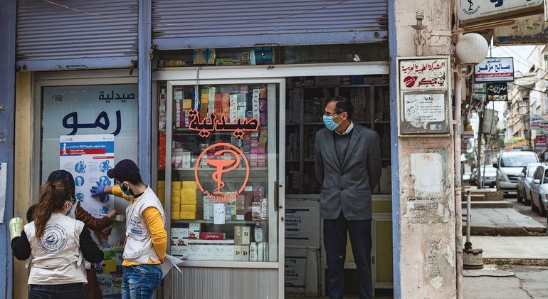 Jirjus works with other volunteers to hang posters providing important instructions on how to protect against the coronavirus, as part of a campaign in the city of Qamishly, northeast Syria.