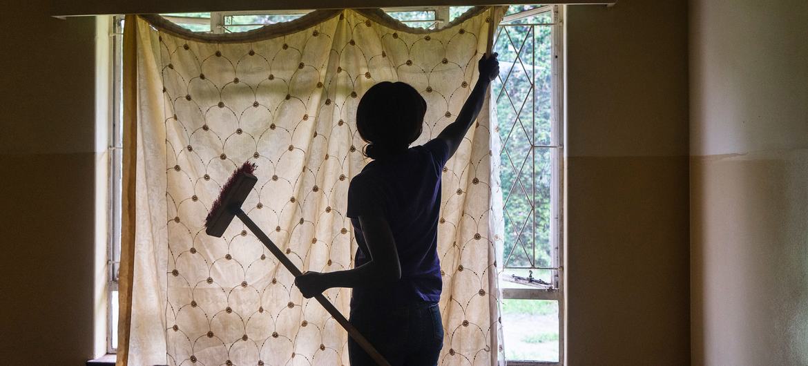 A domestic worker cleans a house in Harare, Zimbabwe.
