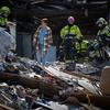 Rescue workers search through the rubble of a bombed building in Kyiv, Ukraine.